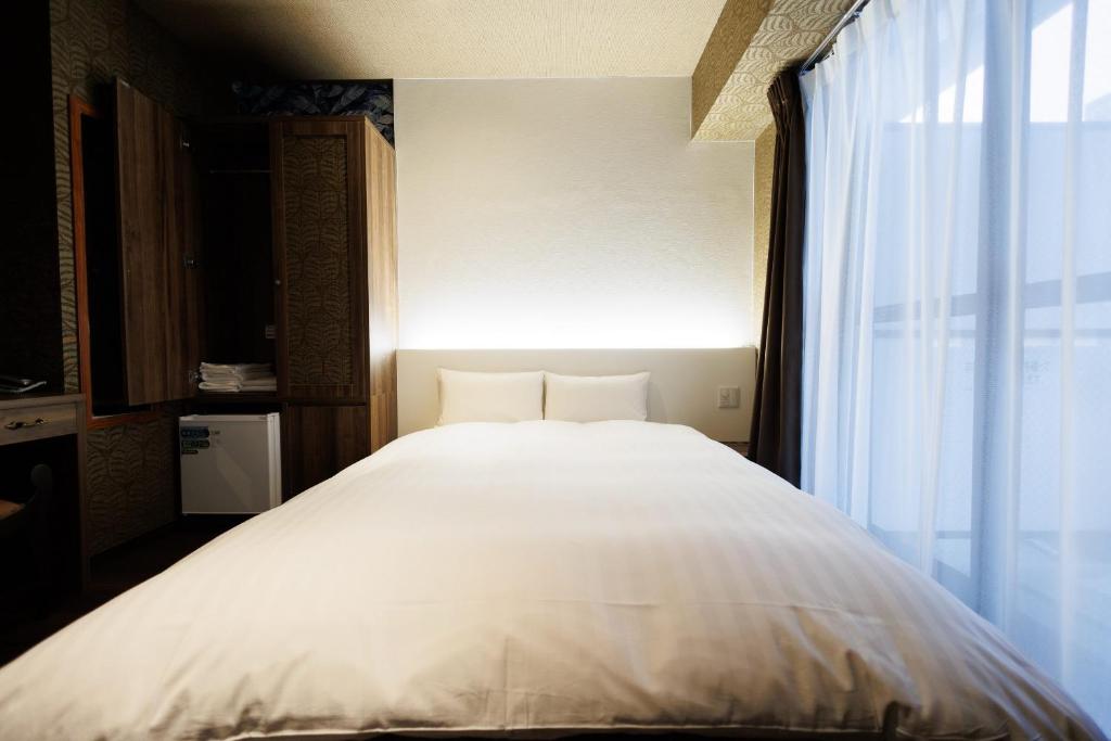 Hotaku HOTEL Akihabaraにあるベッド