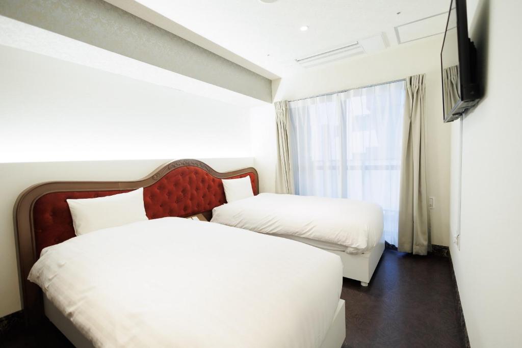 Hotaku HOTEL Akihabaraにあるベッド