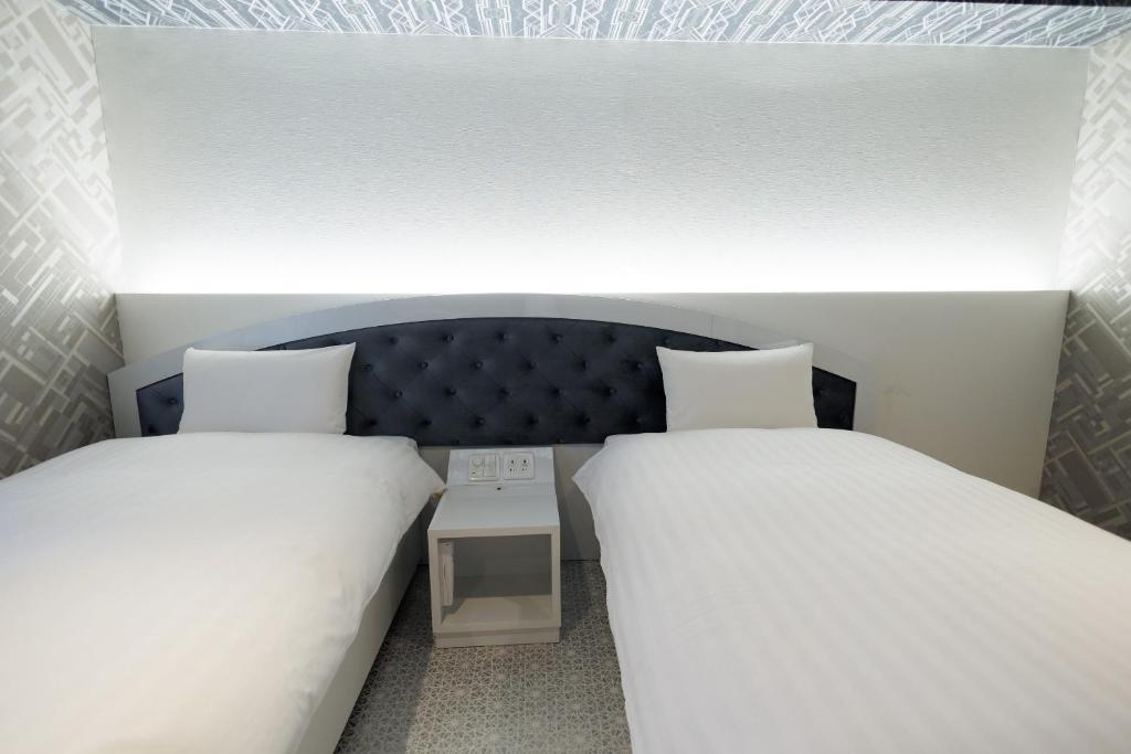 Hotaku HOTEL Akihabaraにあるベッド