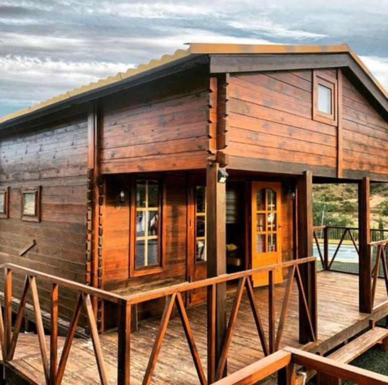 eine Holzhütte auf einem Dock mit einer Veranda in der Unterkunft Casa Los Bartolos in Vélez Rubio