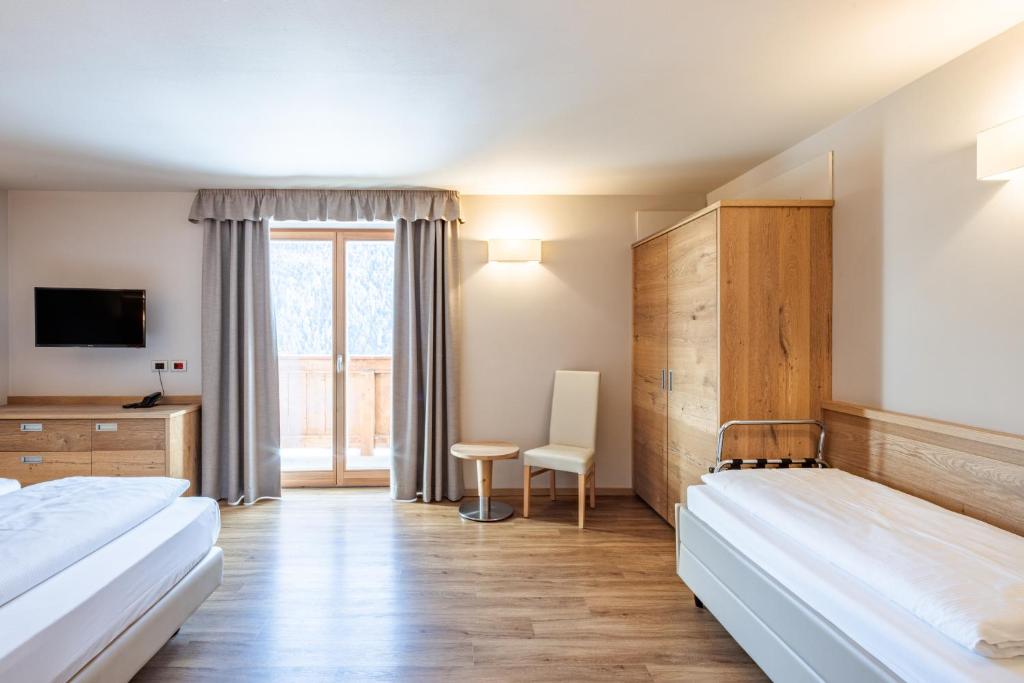 Łóżko lub łóżka w pokoju w obiekcie Albergo Belvedere