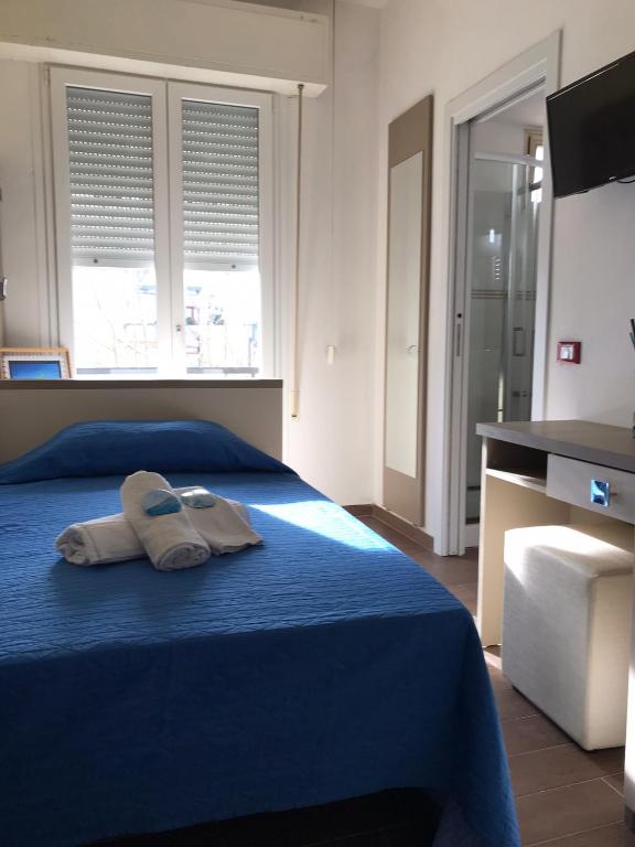 Łóżko lub łóżka w pokoju w obiekcie Hotel Perla Verde