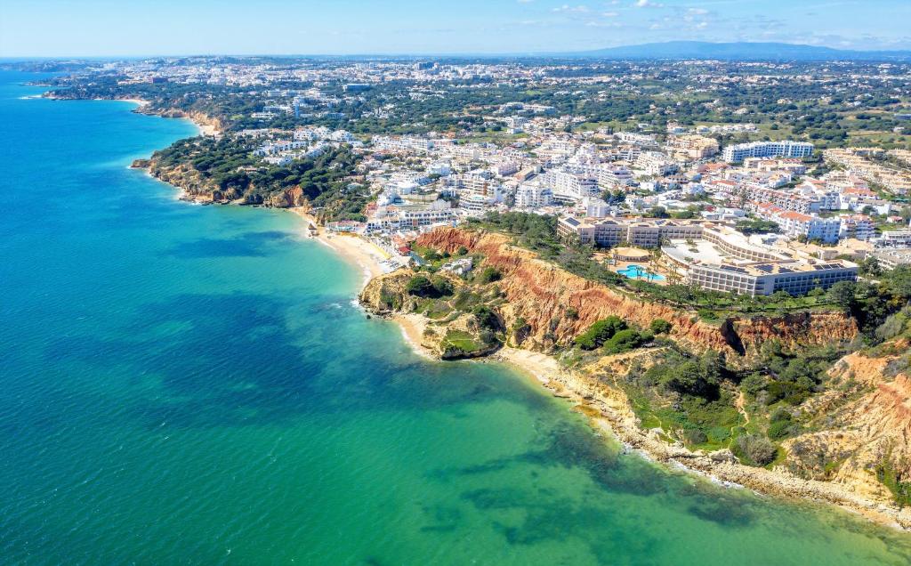 an aerial view of a beach and the ocean at Aquamar Albufeira Aparthotel in Albufeira