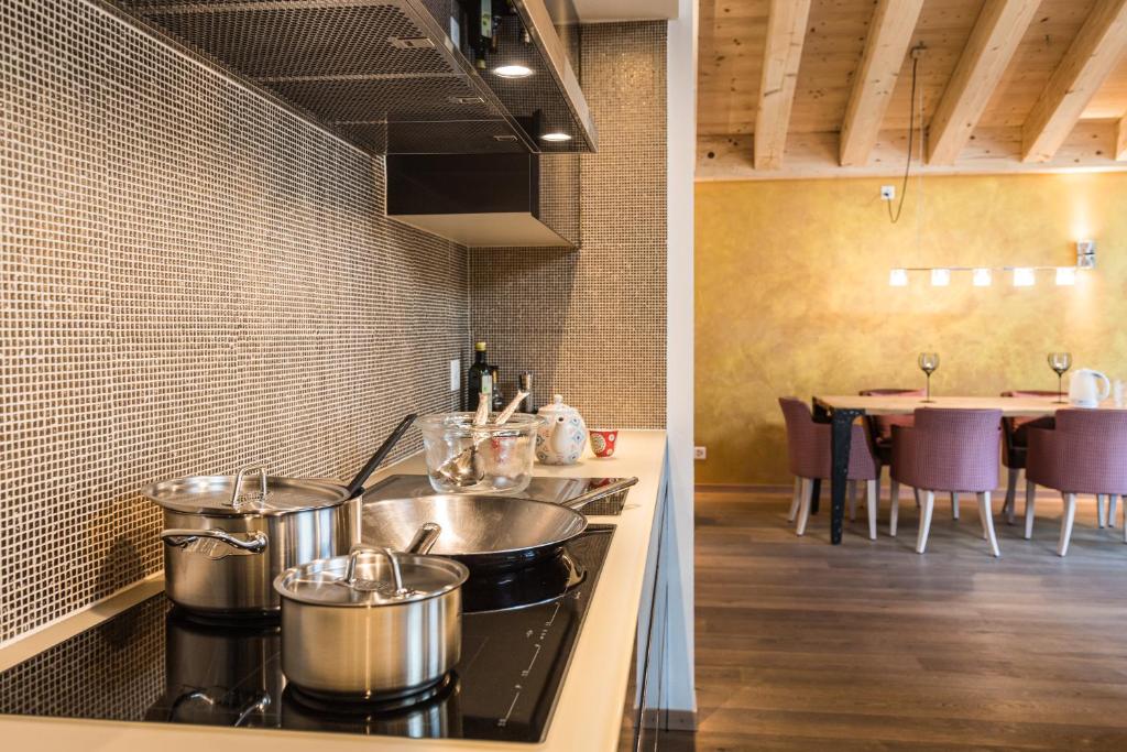 a kitchen with two pots and pans on a stove at Matterhorn Lodge Boutique Hotel & Apartments in Zermatt
