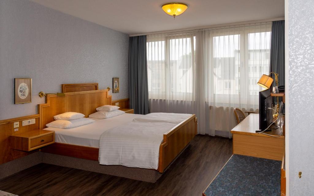 Postel nebo postele na pokoji v ubytování Trip Inn Aschaffenburger Hof
