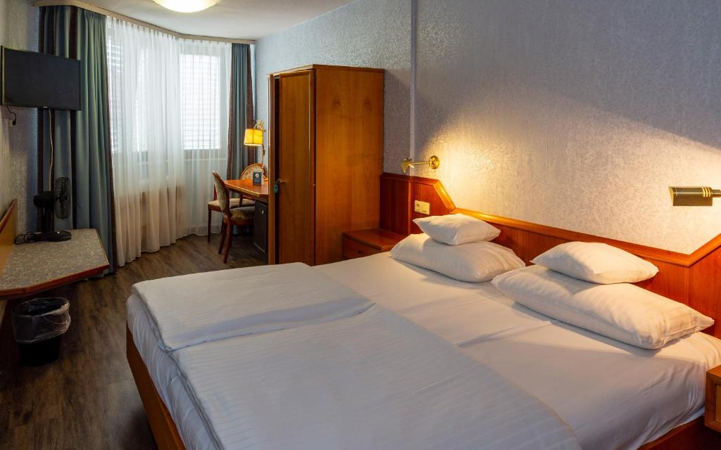 Postel nebo postele na pokoji v ubytování Trip Inn Aschaffenburger Hof
