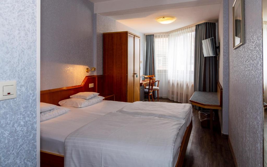 Postel nebo postele na pokoji v ubytování Trip Inn Aschaffenburger Hof