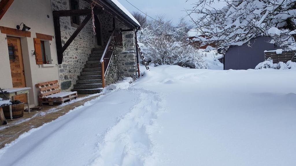a pile of snow next to a house at Appartement entre lac et montagnes in Saint-Paul-en-Chablais