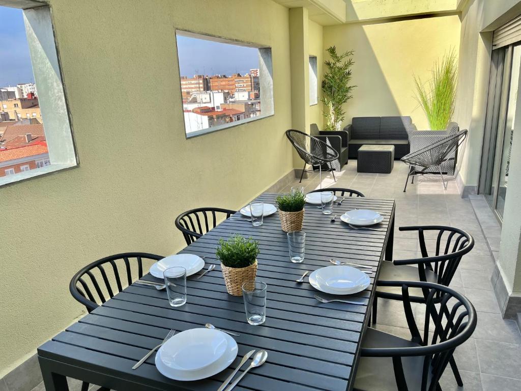 una mesa azul con sillas y platos en ella en Apartamento Vive Zaragoza IV, en Zaragoza