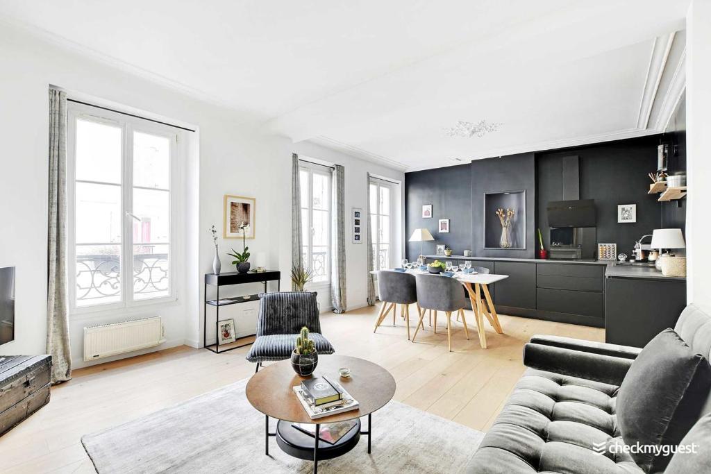un salon avec un canapé et une table dans l'établissement Elegant apartment - 1BR-4P - Les Batignolles, à Paris