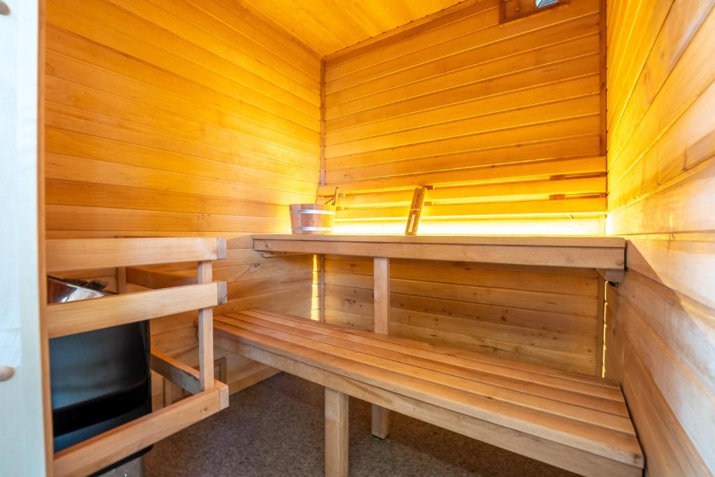 a sauna with wooden walls and wooden counters at L&#39;Escale Royale L&#39;Isle Adam à 20 minutes de Paris CDG in LʼIsle-Adam