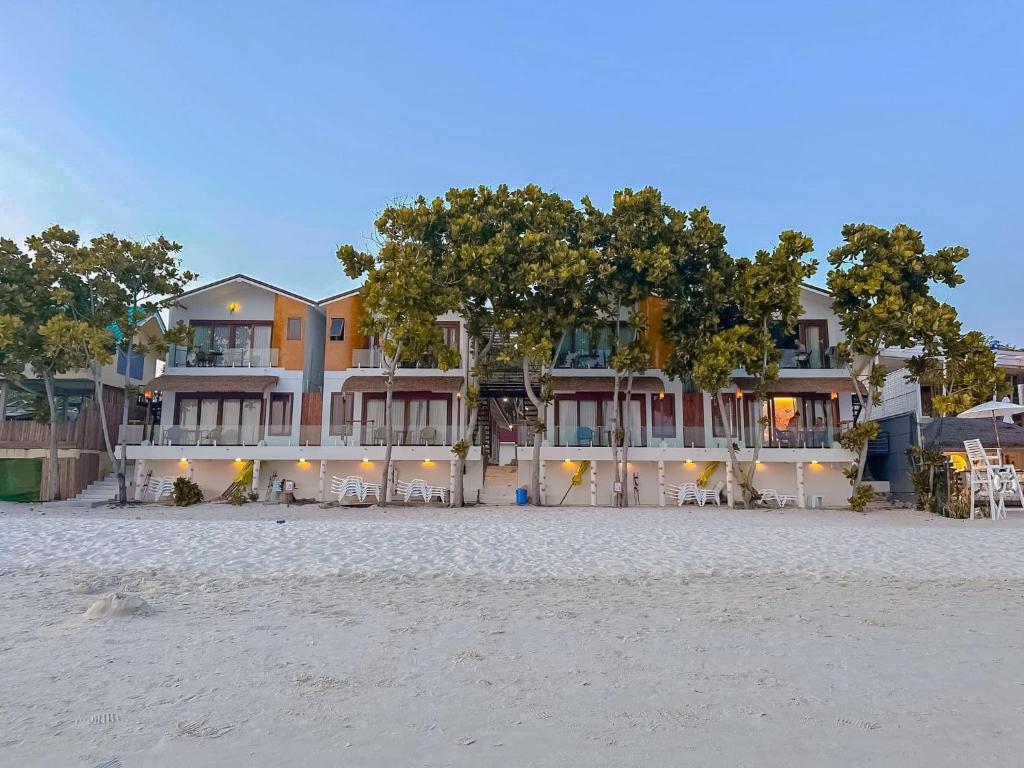 a building on the beach with chairs and trees at Diamond Beach Resort in Ko Samed