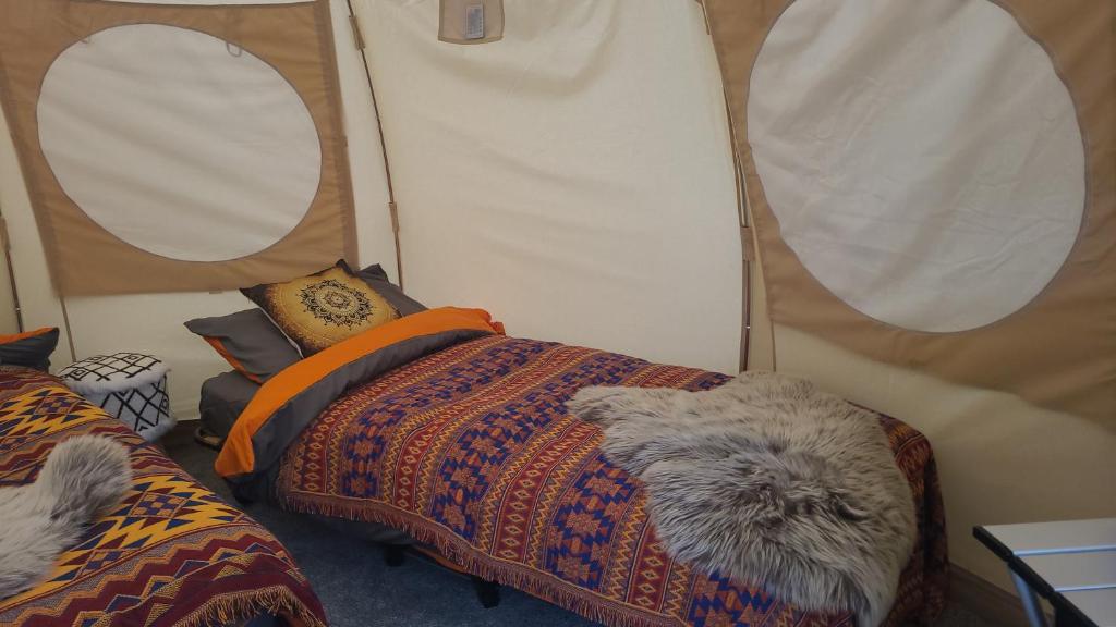 a room with a bed in a tent at glamping in Dromineer in Dromineer