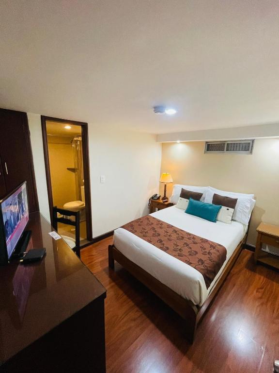 Postel nebo postele na pokoji v ubytování Hotel La Sabana