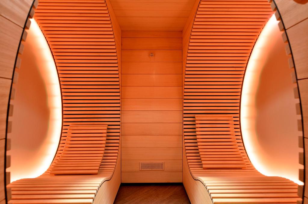 two benches in a room with wooden walls at Matterhorn Lodge Boutique Hotel & Apartments in Zermatt