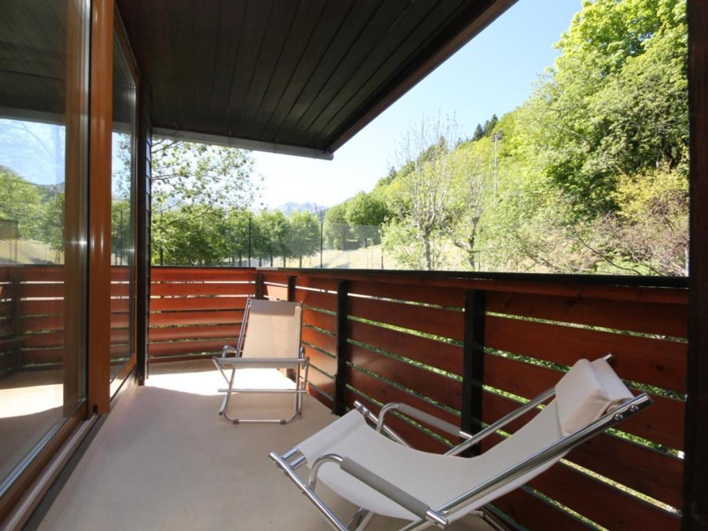 a screened in porch with two chairs on it at Appartement Mont-Dore, 3 pièces, 5 personnes - FR-1-608-161 in Le Mont-Dore