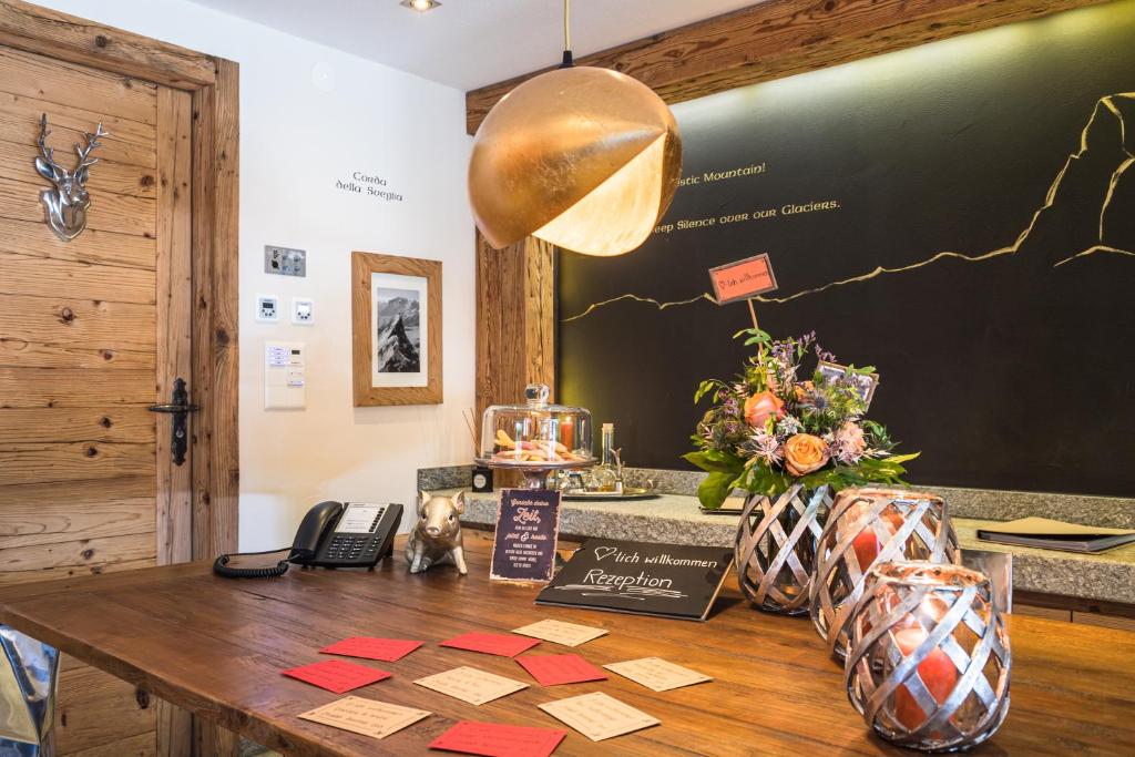 a table with sticky notes on it with a blackboard at Matterhorn Lodge Boutique Hotel & Apartments in Zermatt