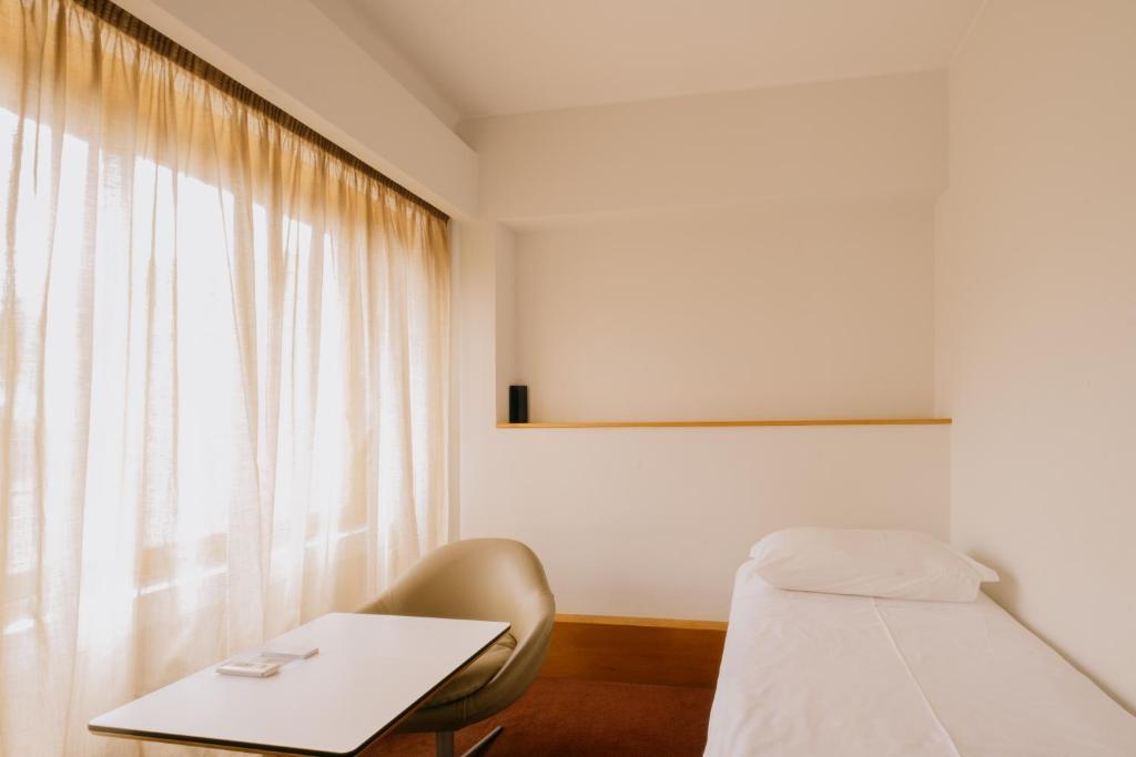 Postel nebo postele na pokoji v ubytování Parque do Rio Ofir Hotel