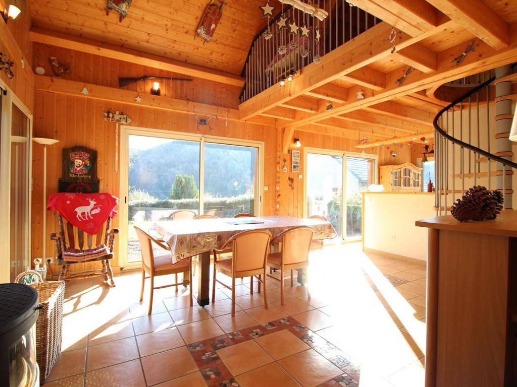 a dining room with a table and chairs at Mont-Dore : Chalet spacieux avec parking et grand terrain - FR-1-608-106 in Le Mont-Dore