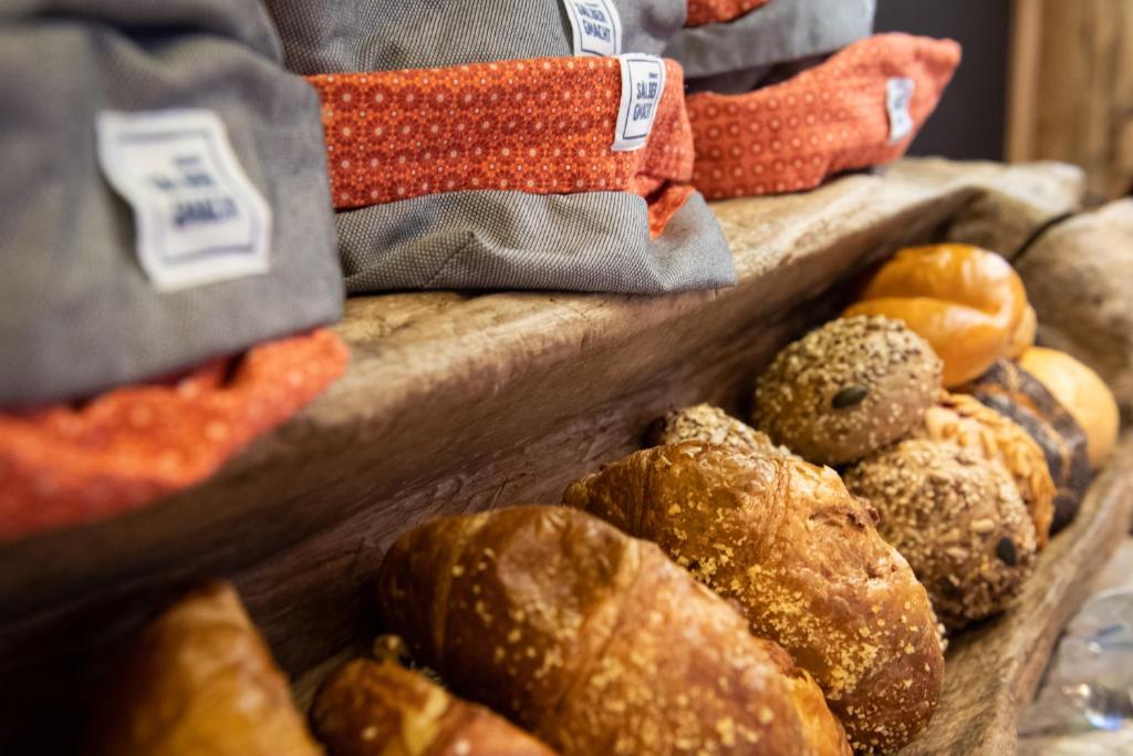 a bunch of different types of bread on display at Matterhorn Lodge Boutique Hotel & Apartments in Zermatt