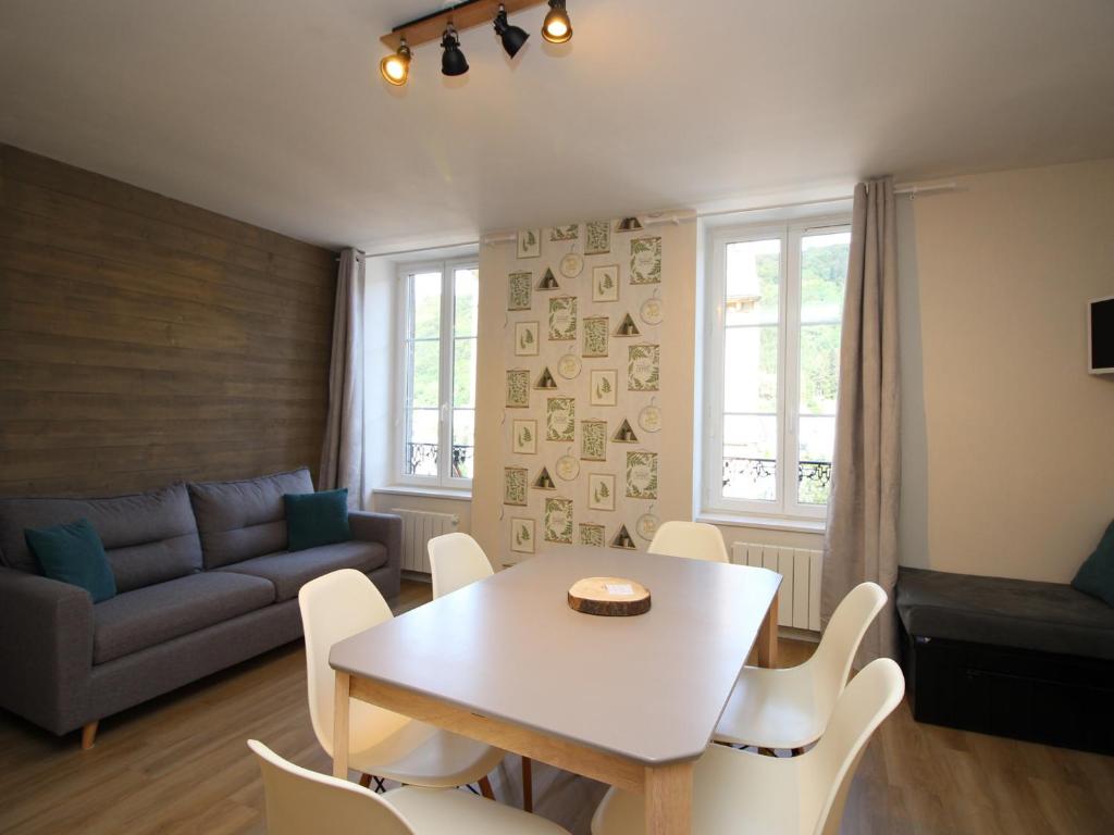 a living room with a table and chairs and a couch at Appartement Mont-Dore, 3 pièces, 5 personnes - FR-1-608-40 in Le Mont-Dore
