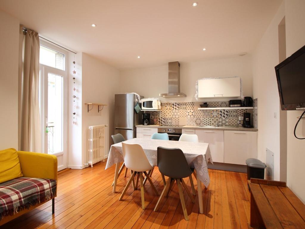 a kitchen and dining room with a table and chairs at Appartement La Bourboule, 3 pièces, 5 personnes - FR-1-608-96 in La Bourboule