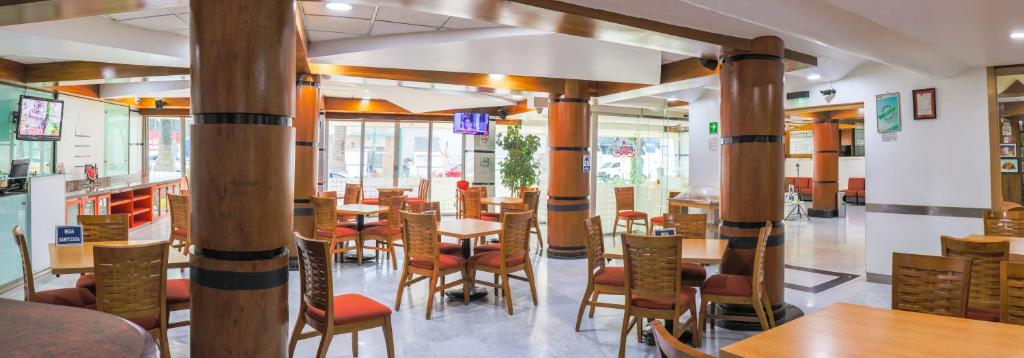 a dining room with wooden tables and chairs at Hotel Palace México in Mexico City