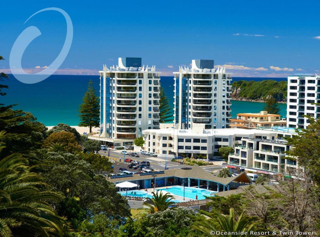 a city with tall buildings and a body of water at Oceanside Resort & Twin Towers in Mount Maunganui