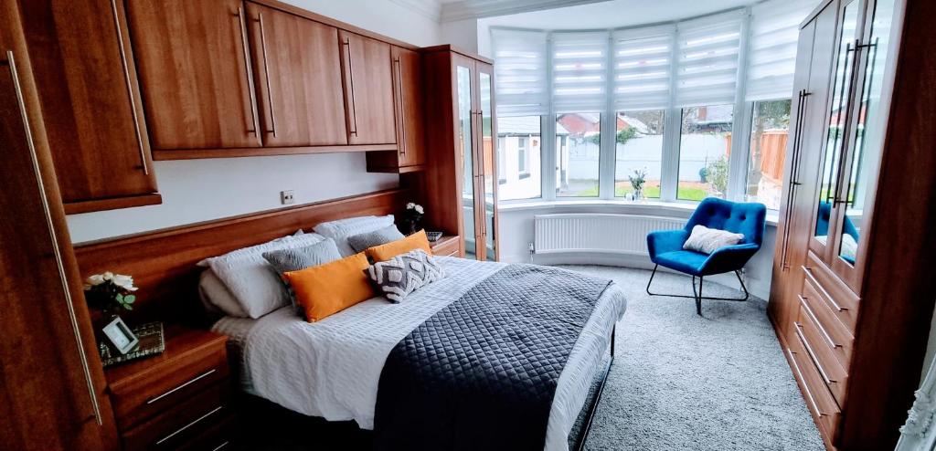 a bedroom with a bed and a blue chair at Oasis Holiday Home Blackpool in Blackpool