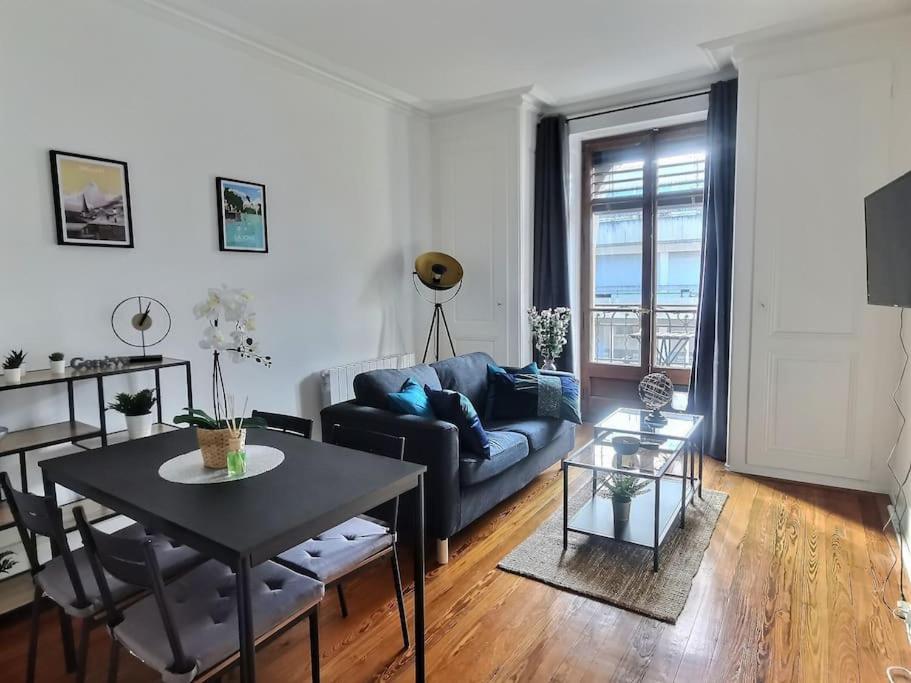a living room with a couch and a table at P&R 2, 2 bedroom, close to center, Plainpalais in Geneva