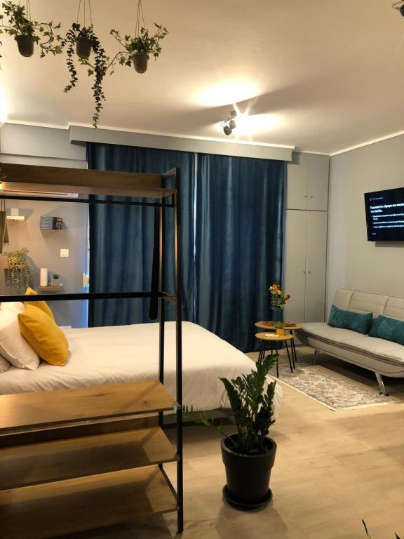 a bedroom with a bunk bed and a couch at G&G city center luxury studio in Thessaloniki