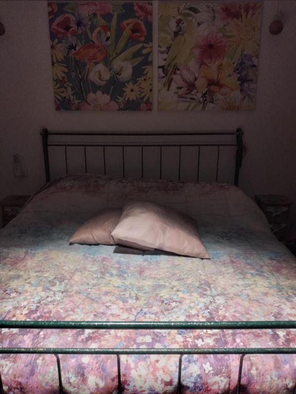 a bed with a pillow on it in a bedroom at Gioia Chic & Economy in Gioia Tauro
