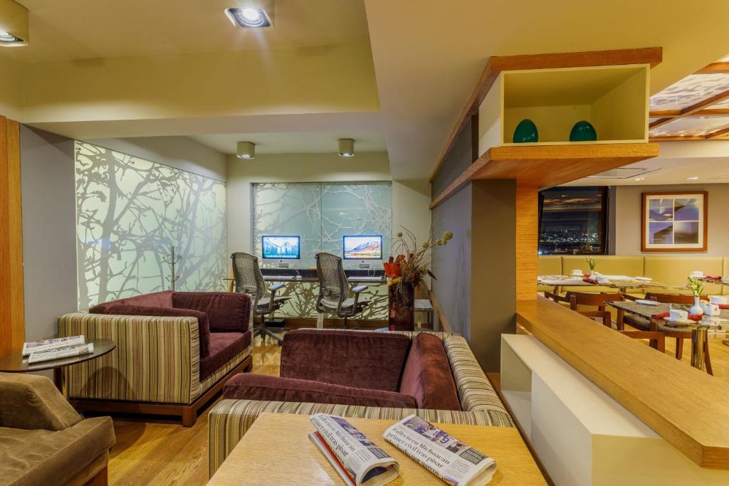 a living room with couches and a dining room at Camino Real Aeropuerto in Mexico City