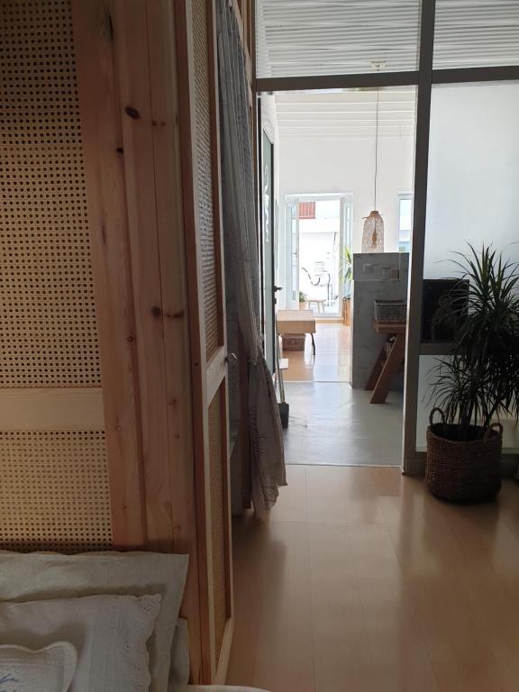 a living room with a large open door and a room with at Aretousa Deluxe Downtown Apartment in Skala