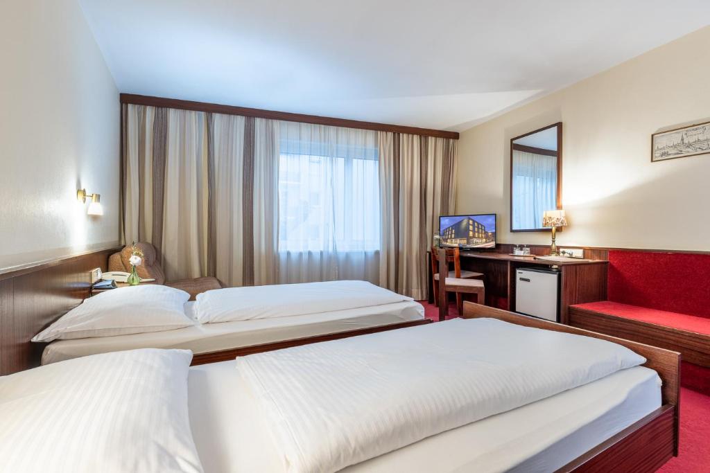 Säng eller sängar i ett rum på Hotel Katharinenhof STANDARD