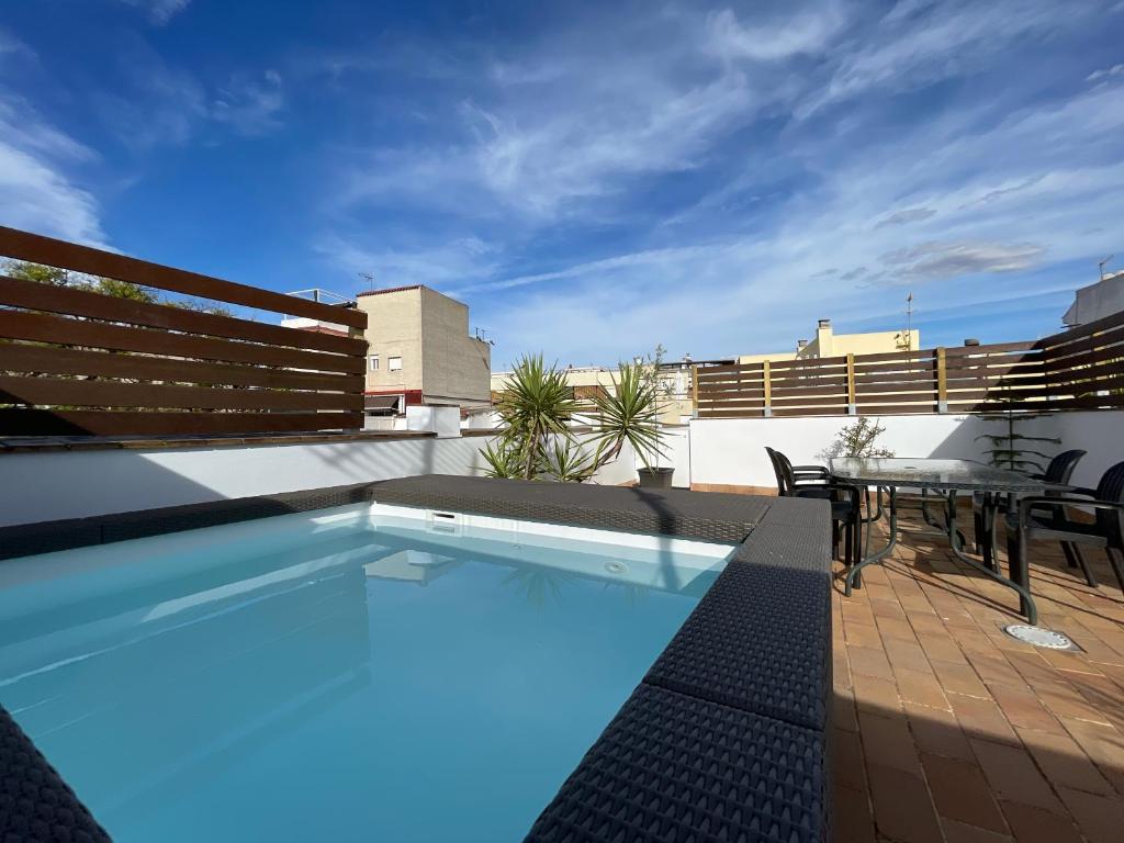 a swimming pool on the roof of a building at DreamsApt Curtidores 6 Suites AT in Seville