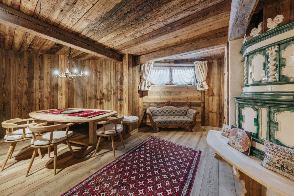 a dining room with a table and chairs and a couch at Luxury Cortina in Cortina dʼAmpezzo