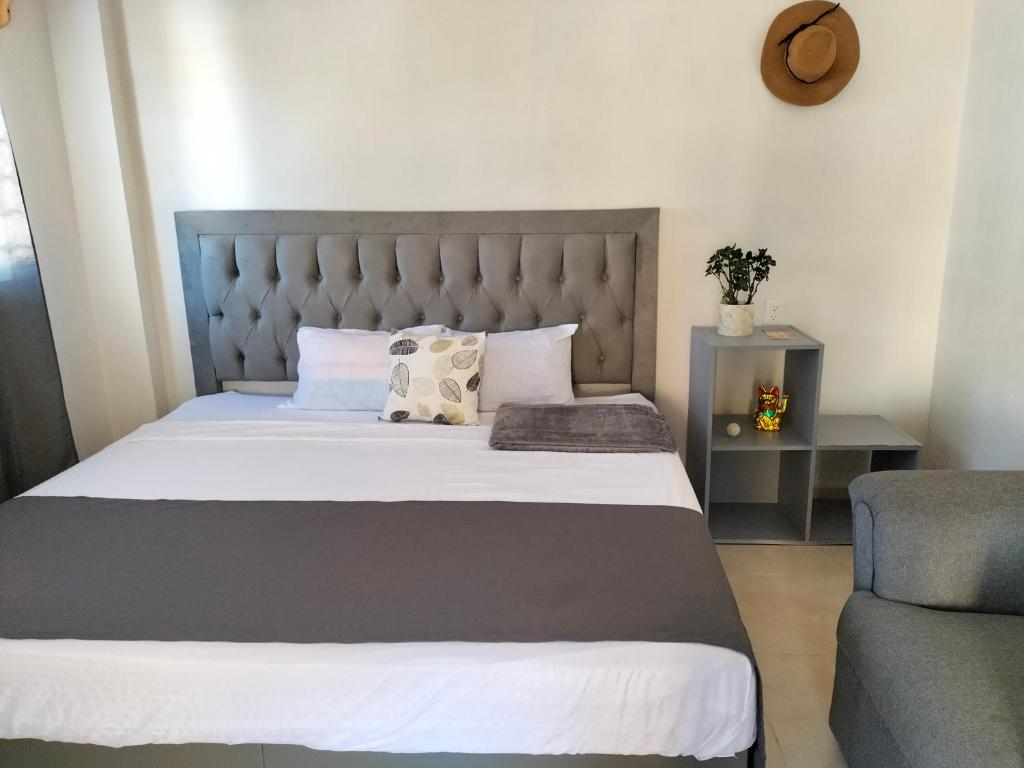 - une chambre avec un grand lit et une chaise dans l'établissement Apartamentos Playa Sur 184, à Mazatlán