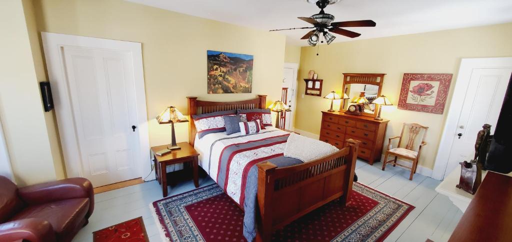 a bedroom with a bed and a couch at The Lark & Loon Inn in Annapolis Royal