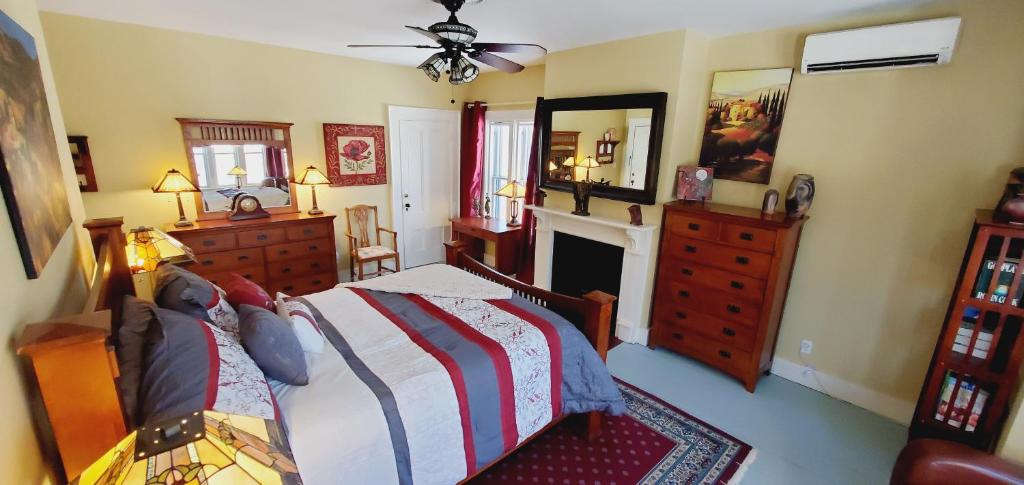 a bedroom with a bed and a fireplace at The Lark & Loon Inn in Annapolis Royal