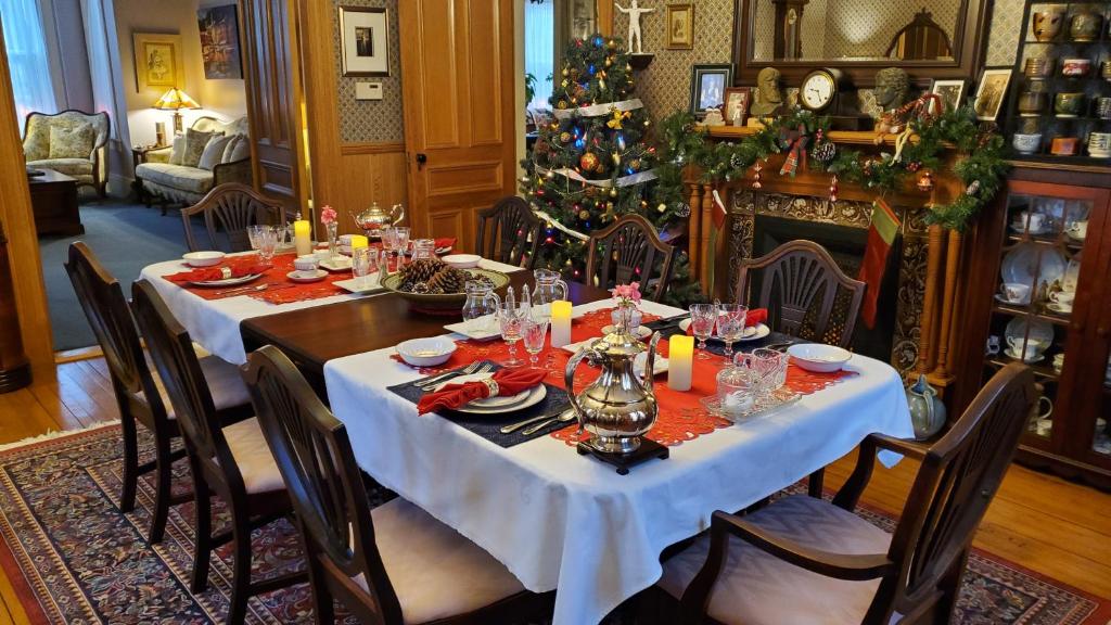 a dining room with a table and a christmas tree at The Lark & Loon Inn in Annapolis Royal