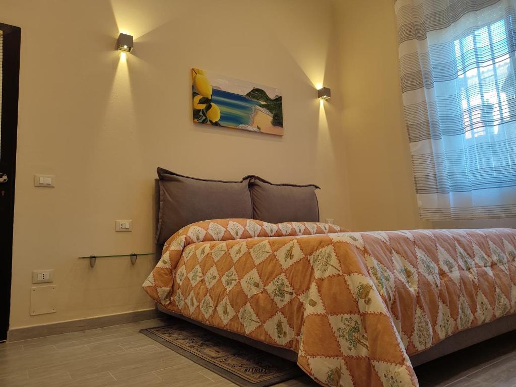 a bedroom with a bed and a window at Camera Nta Cantunera in San Biagio