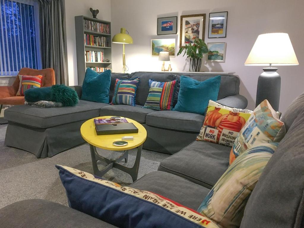 a living room with a couch and a table at Scarborough Rose Apartment in Scarborough
