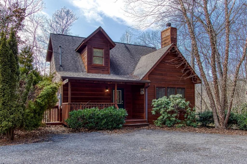 a wooden house with a gambrel roof at Point Of View - Spacious 2 Bedroom With a Loft Just off Glades Road cabin in Gatlinburg