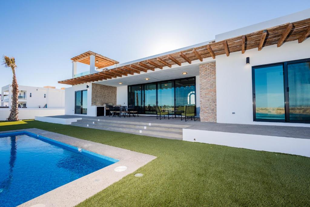 a villa with a swimming pool and a house at Adora House in Puerto Peñasco