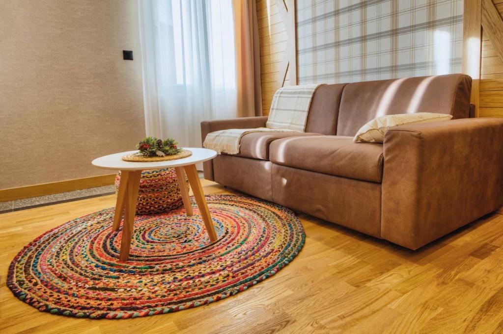 a living room with a couch and a table at WILD BEAUTY Apartment-Modern mountain 2 in Kolašin