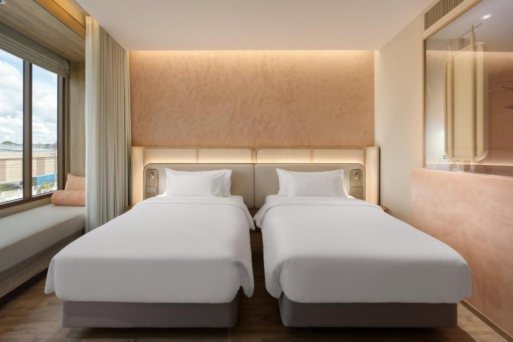 Кровать или кровати в номере Centara Ubon
