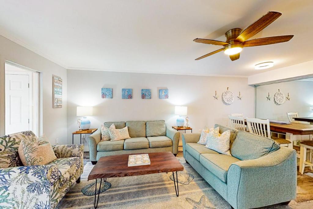 a living room with two couches and a ceiling fan at Chateau La Mer 2A in Destin