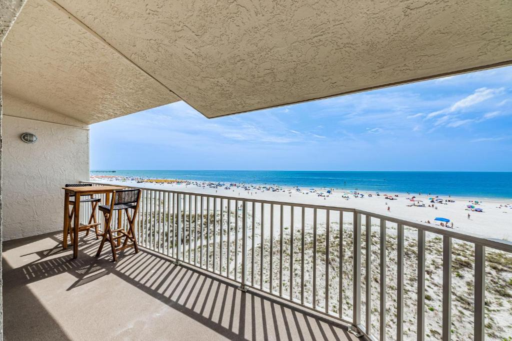 a balcony with a desk and a view of the beach at Villas of Clearwater Beach - Unit A17 in Clearwater Beach