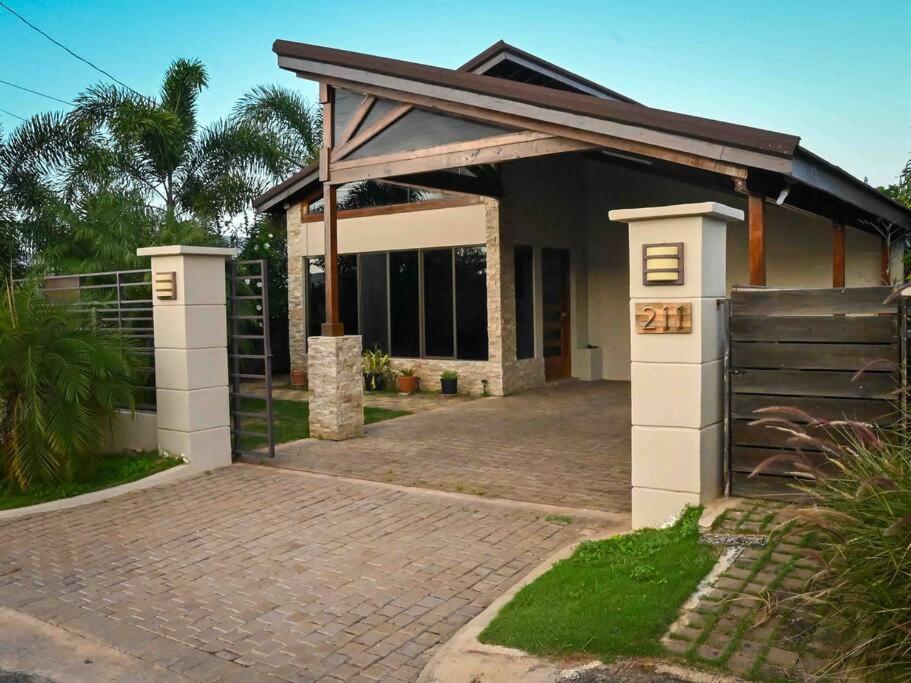 a house with a gate and a driveway at Simply Cassine in Falmouth